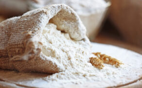 Flour,In,Burlap,Bag,On,Cutting,Board,And,Wooden,Table